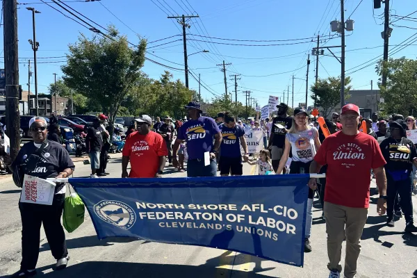 Union members walk in the Labor Day parade