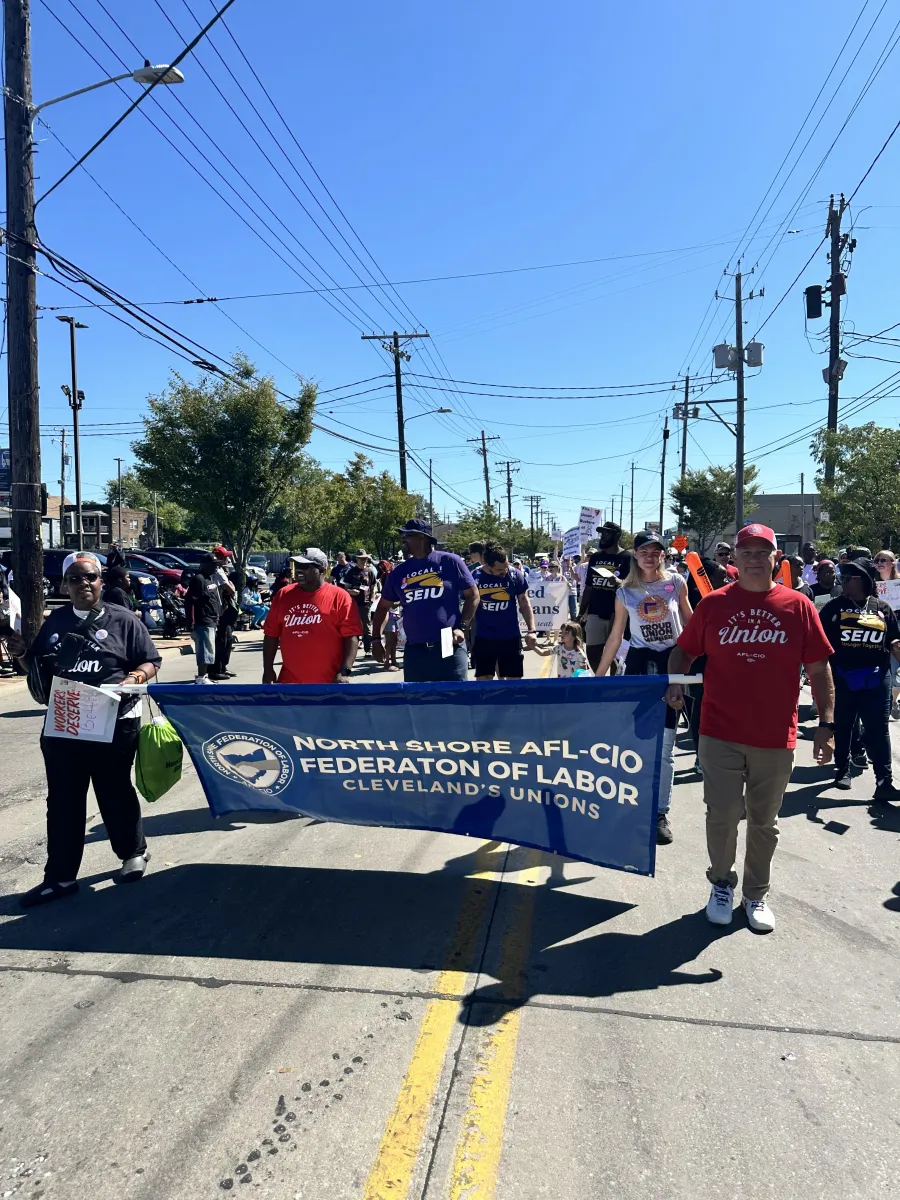 Union members walk in the Labor Day parade