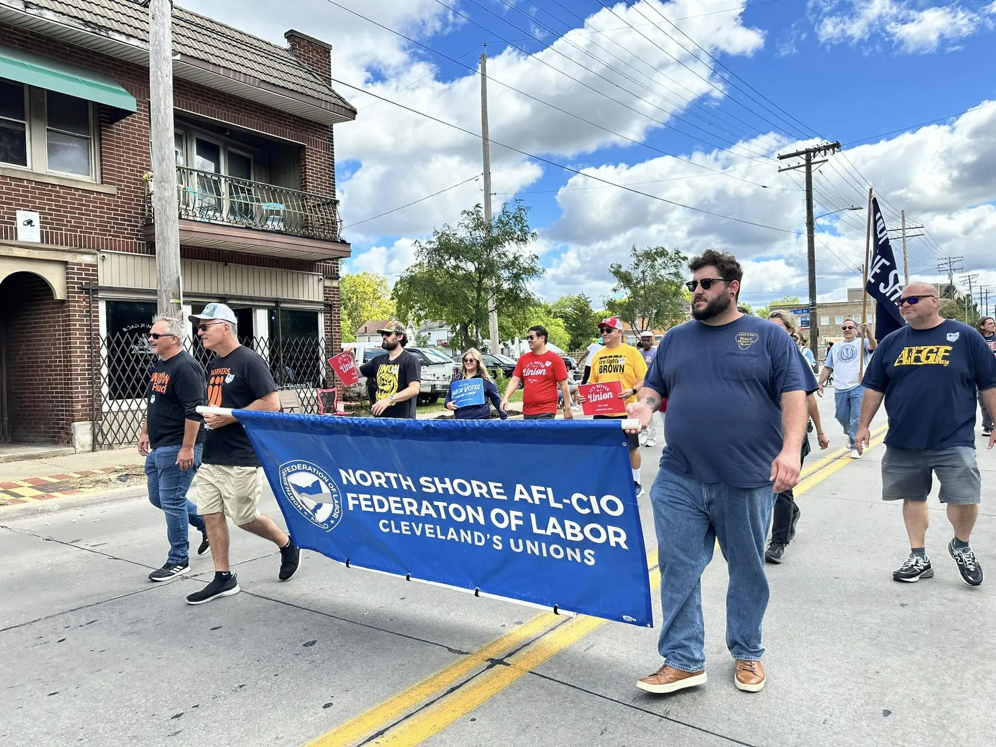 Volunteers walk in the 11th Congressional District parade