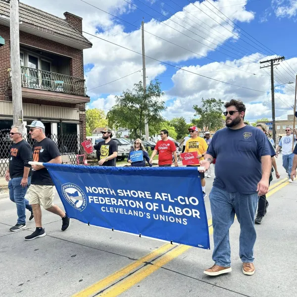 Volunteers walk in the 11th Congressional District parade